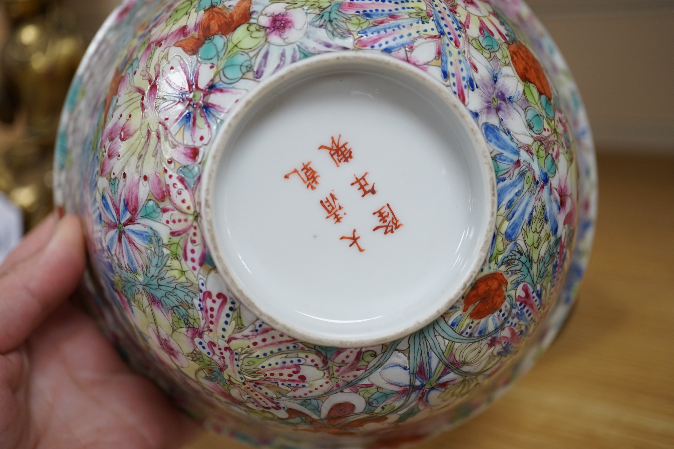 A Chinese 'Thousand Flower' enamelled porcelain bowl, Qianlong mark, early 20th century on hardwood stand, 17cm high